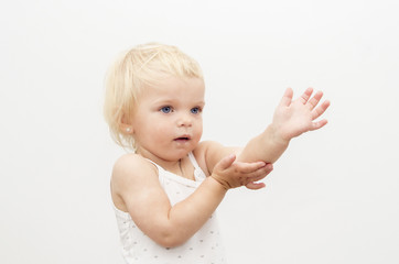 portrait of little baby girl with blond hair on white background