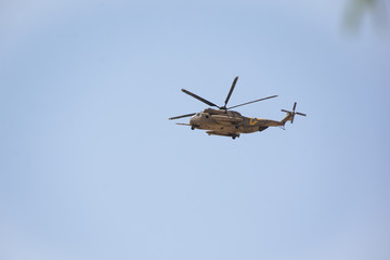 Fototapeta na wymiar IDF apache helicopter in training flight over Arad Israel