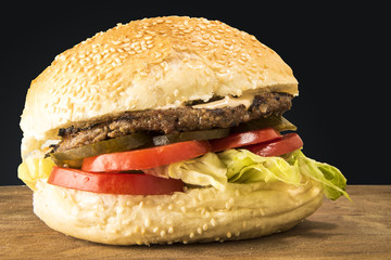 Delicious Burger with tomato and pickles  