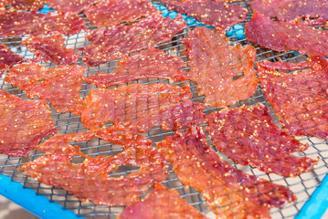Close up textured of seasoning sun dried pork using local procedure of food preservation in countryside Thailand.
