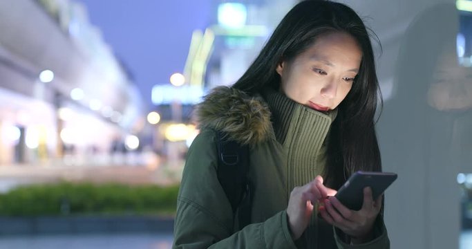 Woman look at mobile phone at night
