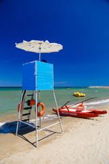 Lifeguard tower and a typical red catamaran in Italy beach. Conception of rescue.