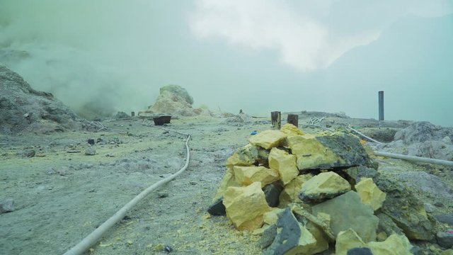 Extraction of sulfur in the crater of a volcano. Sulfur gas, smoke. Kawah Ijen, crater with acidic crater lake where sulfur is mined. Ijen volcano complex is a group of stratovolcanoes in the