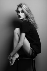 Fototapeta na wymiar Portrait of young beautiful girl with blonde hair. Fashion photo Hairstyle. Make up. Vogue Style. Black and white photo