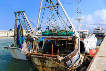 Fishing boat with fishing nets after fishing in a harbor.
