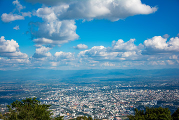 Beautiful landscape mountain view with green forest , blue sky, cloudy and the city. The good travel for relax , the attractions in northern of Thailand.