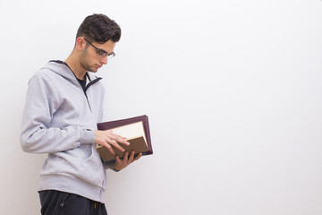 young student with books on the white wall
