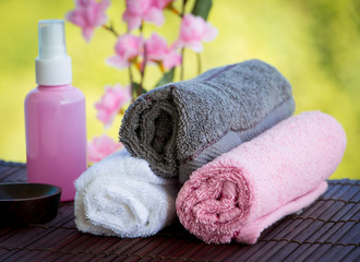 Obraz na płótnie Canvas Body Care Therapy Composition Including Towels Oil and Flowers