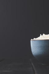 close-up shot of bowl of tasty rice on black table