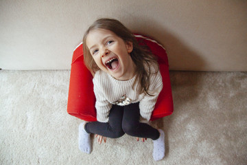 cheeky little girl playing fun at home