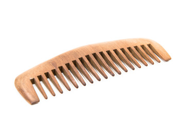 Fototapeta premium Brown hair comb is placed on a white floor.