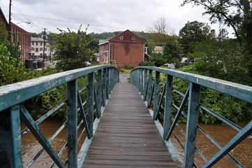 Naklejka na ściany i meble Wooden Bridge Over a River