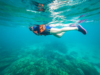 Beautiful women are diving snorkeling in the sea.