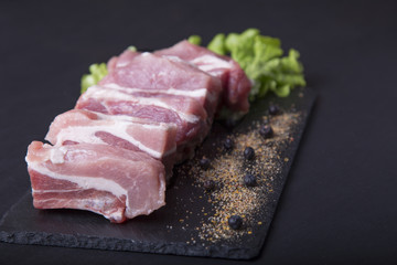 Fresh pork ribs on a dark background. Meat for cooking