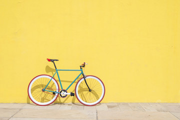 Ein City-Fahrrad-Festfahrrad auf gelber Wand