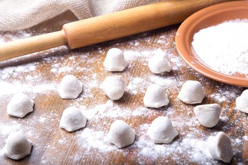Uncooked russian pelmeni. Process of making pelmeni, ravioli or dumplings with meat