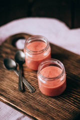 strawberry yogurt on white wooden table. Fresh yogurt. Healthy food concept. High resolution product. Top view