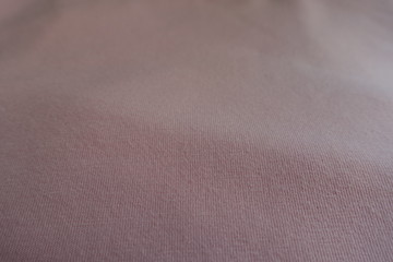 Texture of simple unprinted light pink fabric