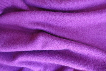 Fototapeta na wymiar Rippled thin simple fuchsia colored knitted fabric