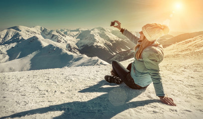 Happy woman relaxing on the top of mountain under blue sky with