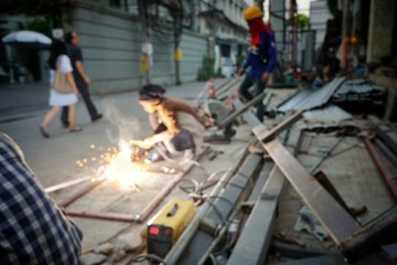 BANGKOK, THAILAND - JANUARY 20, 2018:  Blurred welder is welding the steel structure in the Soi Kasemson2, Pathum wan.