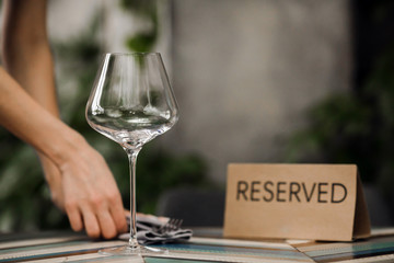 Hands serving reserved table