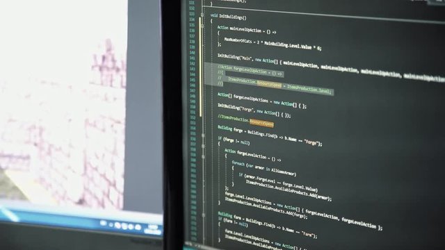 Shooting from the computer screen: virtual code and command line in the simulation program. A programmer at work. Close-up, there are no people in the frame.