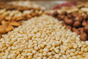 Nuts mix in a canvas bag in table. Ten kinds of nuts: pecan, brazil, cedar, sunflower, hazelnut, almond, peanut, walnut, pistachio, cashew.