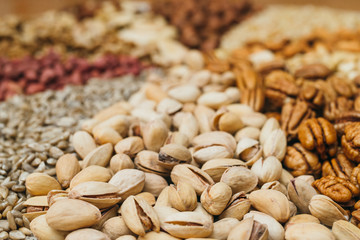 Nuts mix in a canvas bag in table. Ten kinds of nuts: pecan, brazil, cedar, sunflower, hazelnut, almond, peanut, walnut, pistachio, cashew.