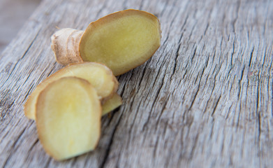 Fresh ginger on wood texture.