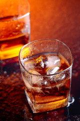 Glass of scotch whiskey with natural ice .