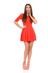 Surprised Young Woman Is Holding Hand On Chin And Looking Away