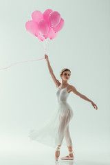 Fototapeta na wymiar elegant ballerina with pink balloons, isolated on white