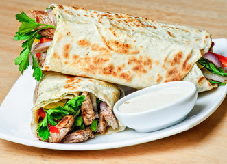 Eastern traditional shawarma plate with sauce.