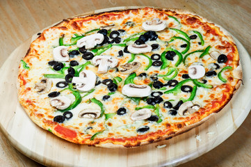 Delicious fresh pizza served on wooden table.