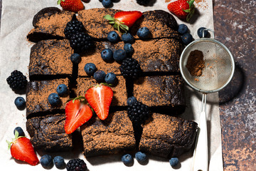 dessert - chocolate brownies with fresh berries, top view closeup