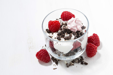 dessert with fresh raspberries, chocolate biscuits and cream, top view