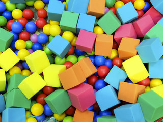 Colored balls and soft cubes in the kiddie pool.
