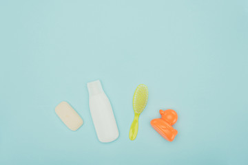top view of baby toy and bathroom accessories isolated on blue