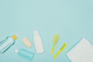 top view of bathroom accessories scattered isolated on blue