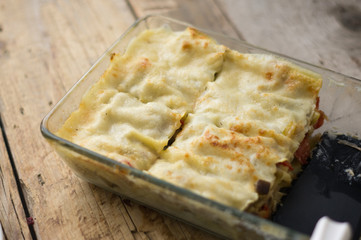 Homemade roasted vegetable lasagna with zucchini, eggplant, red pepper and béchamel on the wooden rustic table