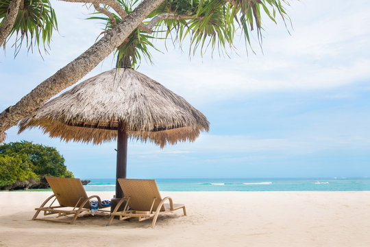 Sun loungers white tropical beach blue ocean shore
