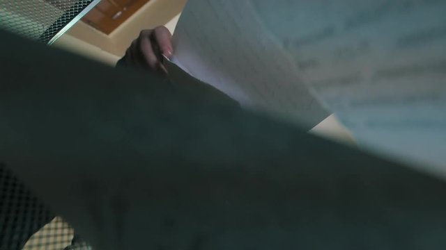 Man throwing pices of paper in waste can bin - bottom view