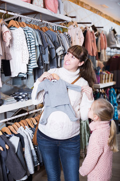 Family in baby’s cloths shop