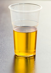 Fresh beer in a plastic glass on the table