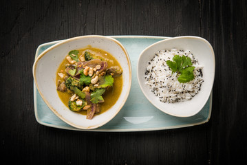 Top view of vegan dish, Thai green curry and risotto with black sesame