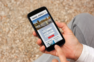 Hands holding smart phone with travel agency concept on screen. All screen content is designed by me