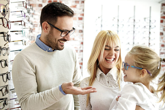 Father And Daughter Choosing Glasses