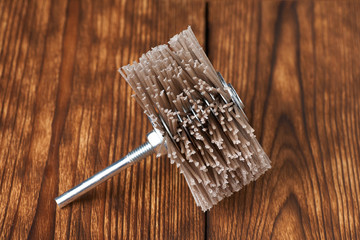 Grinding brush nylon for a drill on a wood background