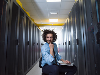 Fototapeta premium engineer working on a laptop in server room